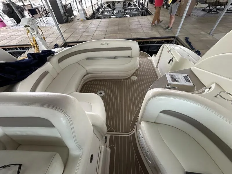 Slide: The Image of 2005 Sea Ray 320 Sun Dancer interior with white leather seating and wood-style flooring. - 3