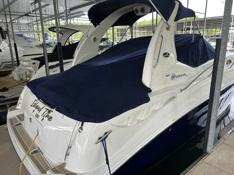 Slide: The Image of 2005 Sea Ray 320 Sun Dancer yacht docked with navy cover in marina. - 5