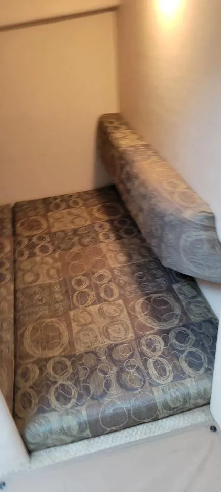 Slide: The Image of 2004 Sea Ray Sundancer 260 cabin interior with patterned cushions. - 12