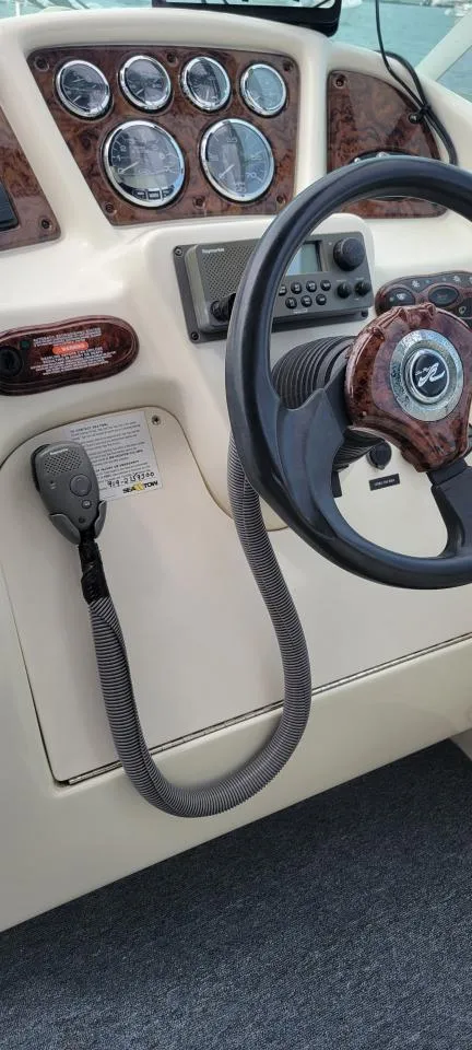 Slide: The Image of 2004 Sea Ray Sundancer 260 helm with steering wheel and instrument panel. - 14