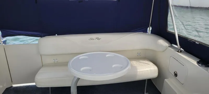 Slide: The Image of Interior of 2004 Sea Ray Sundancer 260 with seating and table, featuring blue and white design. - 16