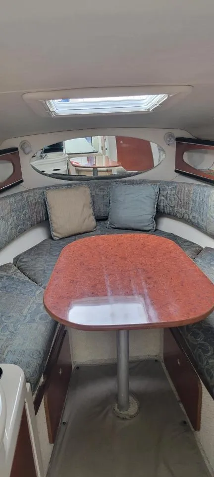 Slide: The Image of 2004 Sea Ray Sundancer 260 cabin interior with seating and table. - 22