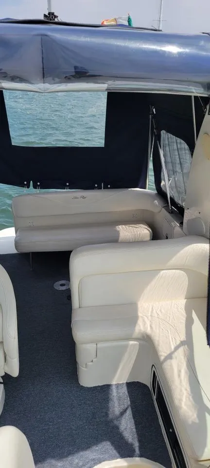 Slide: The Image of 2004 Sea Ray Sundancer 260 interior with seating, covered deck, and ocean view. - 27