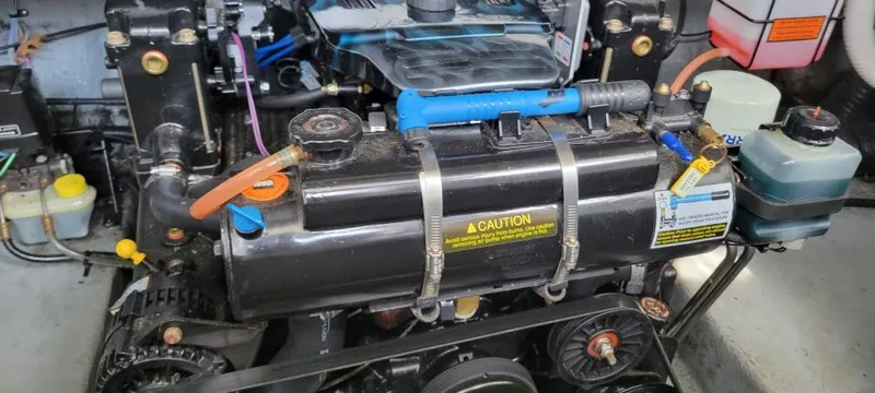 Slide: The Image of Engine compartment of a 2004 Sea Ray Sundancer 260 boat, showing detailed components and connections. - 29