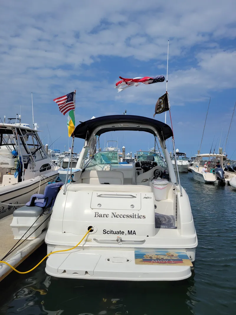 Slide: The Image of 2004 Sea Ray Sundancer 260 docked in Scituate, MA, with flags and clear skies. - 3