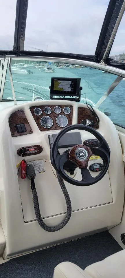 Slide: The Image of 2004 Sea Ray Sundancer 260 helm with steering wheel and instrument panel. - 31