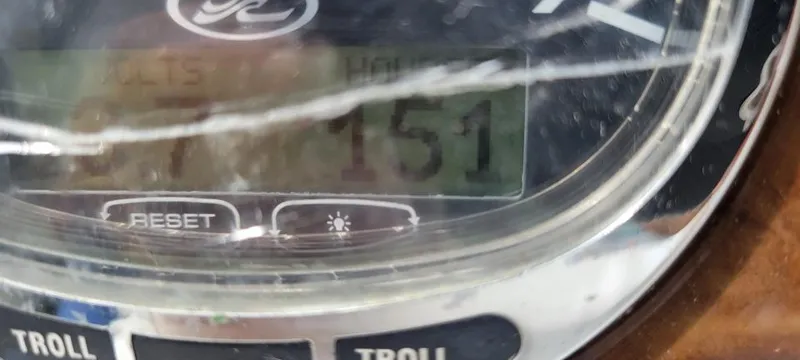 Slide: The Image of Close-up of a Sea Ray Sundancer 260 boat gauge, displaying 151 hours. - 38