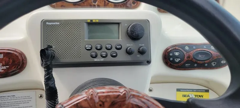 Slide: The Image of 2004 Sea Ray Sundancer 260 dashboard with Raymarine radio and steering wheel. - 39