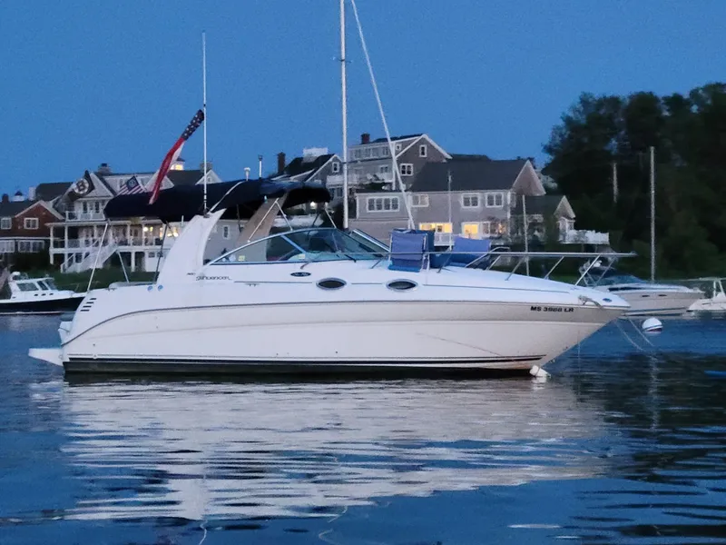 Slide: The Image of 2004 Sea Ray Sundancer 260 boat docked near waterfront homes at dusk. - 4