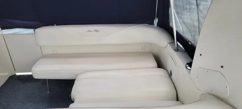 Slide: The Image of 2004 Sea Ray Sundancer 260 interior with beige seating and dark blue canopy. - 41