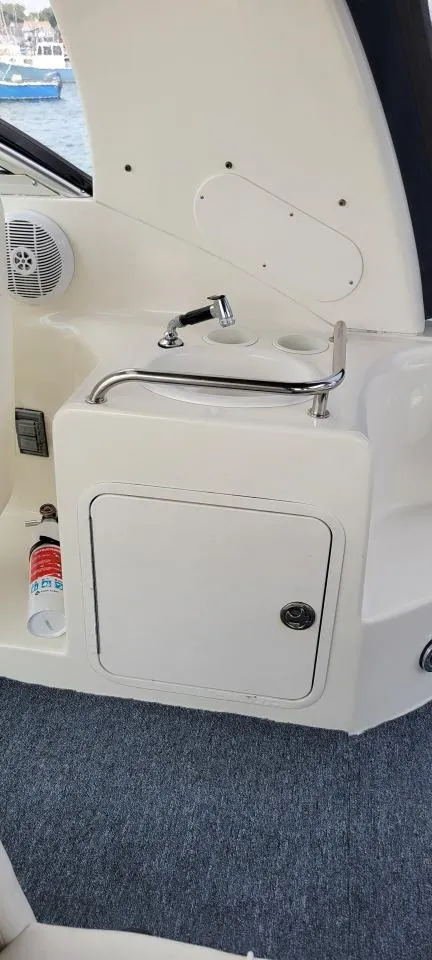 Slide: The Image of 2004 Sea Ray Sundancer 260 interior with sink and storage cabinet. - 42