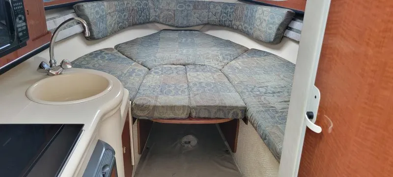 Slide: The Image of 2004 Sea Ray Sundancer 260 cabin interior with bed and sink. - 43