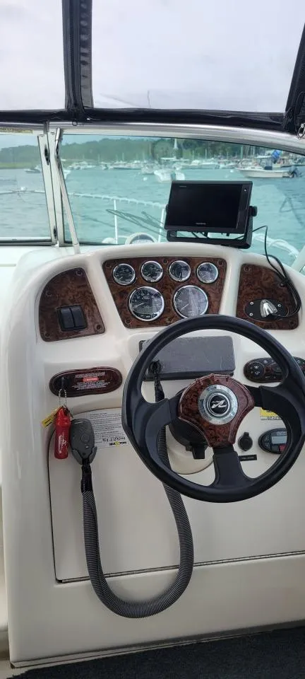 Slide: The Image of 2004 Sea Ray Sundancer 260 helm with steering wheel and instrument panel. - 44