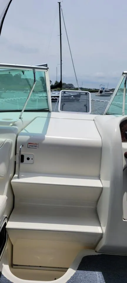 Slide: The Image of 2004 Sea Ray Sundancer 260 boat interior with steps and windshield view. - 5
