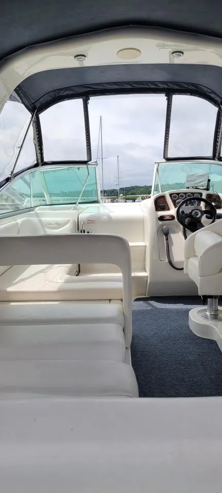 Slide: The Image of 2004 Sea Ray Sundancer 260 boat interior with helm, seating, and canopy. - 9