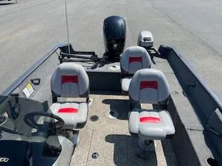 Slide: The Image of 2015 Tracker Pro Guide V-175 SC boat interior with four seats and motor. - 12