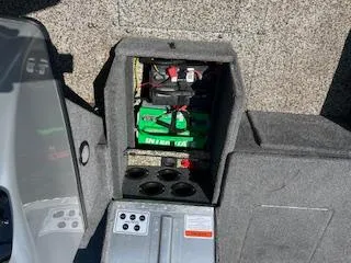 Slide: The Image of 2015 Tracker Pro Guide V-175 SC boat battery compartment with green battery and wiring. - 14