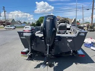 Slide: The Image of 2015 Tracker Pro Guide V-175 SC boat with outboard motor in a parking lot. - 5