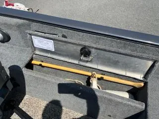 Slide: The Image of 2015 Tracker Pro Guide V-175 SC boat storage compartment with safety equipment. - 7