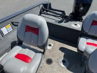 Slide: The Image of 2015 Tracker Pro Guide V-175 SC boat interior with gray and red seating. - 8