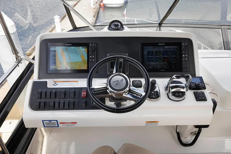 Slide: The Image of 2017 Sea Ray Fly 400 helm with dual navigation screens and modern controls. - 10