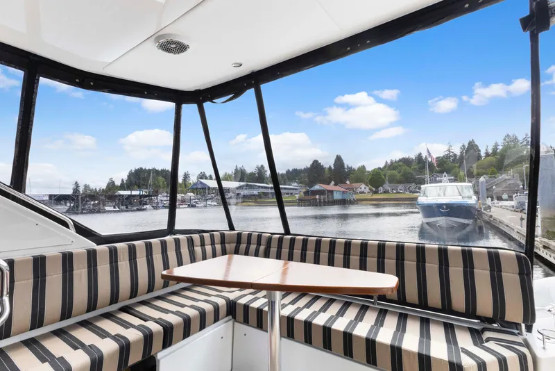 Slide: The Image of Interior view of 2017 Sea Ray Fly 400 yacht with striped seating and waterfront scenery. - 11