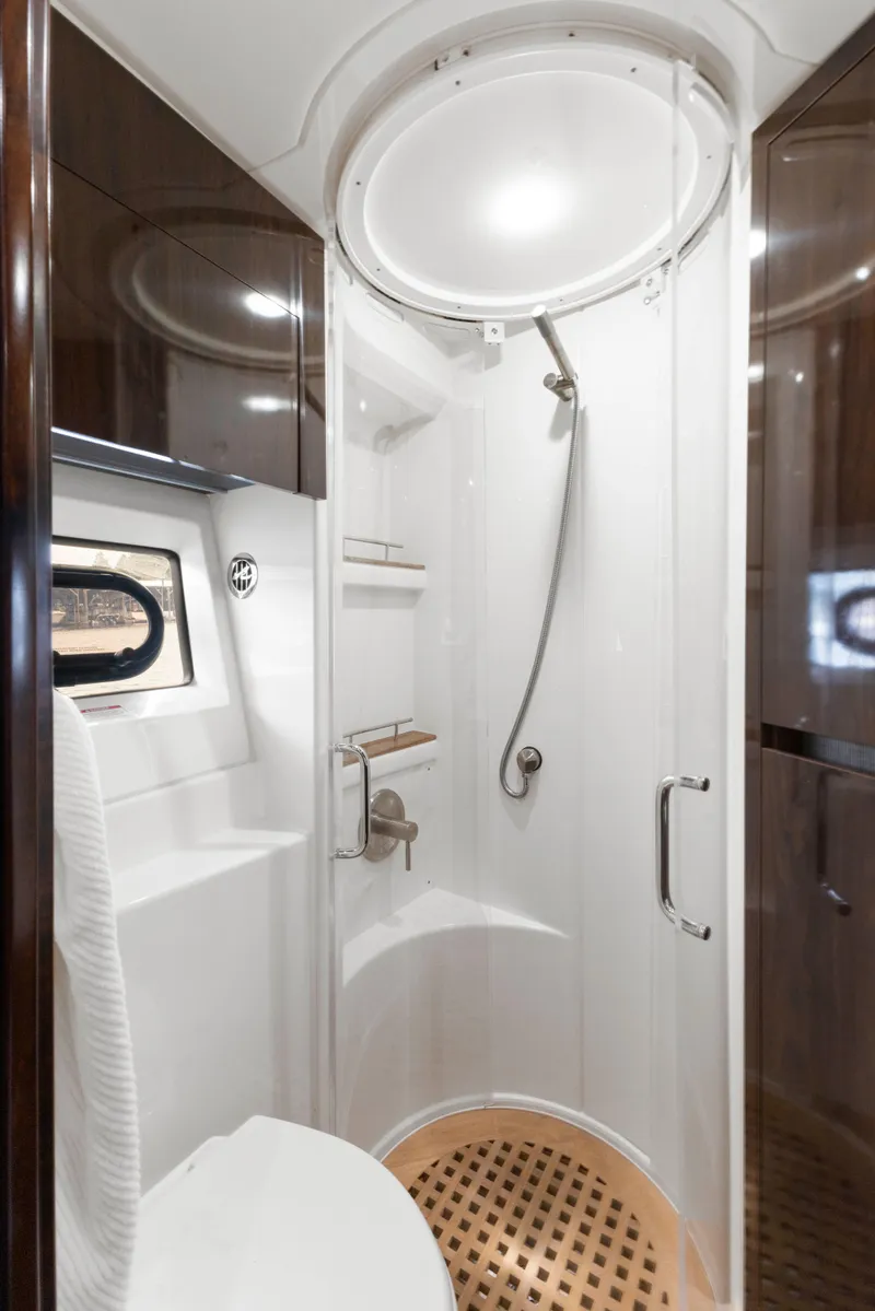 Slide: The Image of Luxurious bathroom in 2017 Sea Ray Fly 400 yacht with modern shower and elegant wood accents. - 23