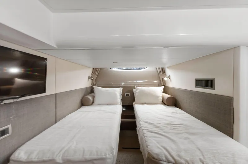 Slide: The Image of Interior of 2017 Sea Ray Fly 400 yacht with twin beds and a wall-mounted TV. - 27