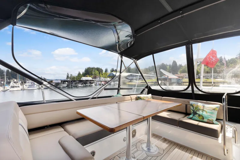 Slide: The Image of Interior view of 2017 Sea Ray Fly 400 yacht with seating and table, overlooking marina. - 3