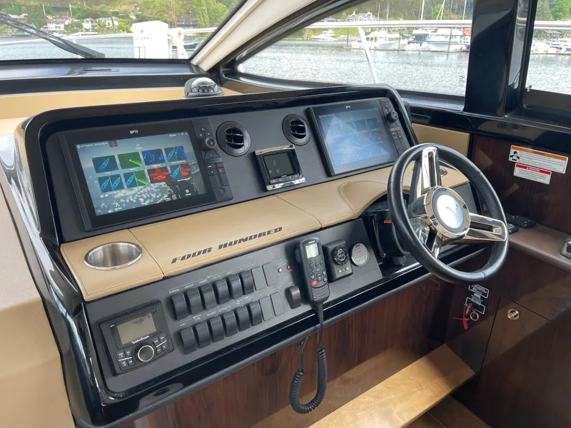 Slide: The Image of 2017 Sea Ray Fly 400 helm with advanced navigation systems and steering wheel. - 33