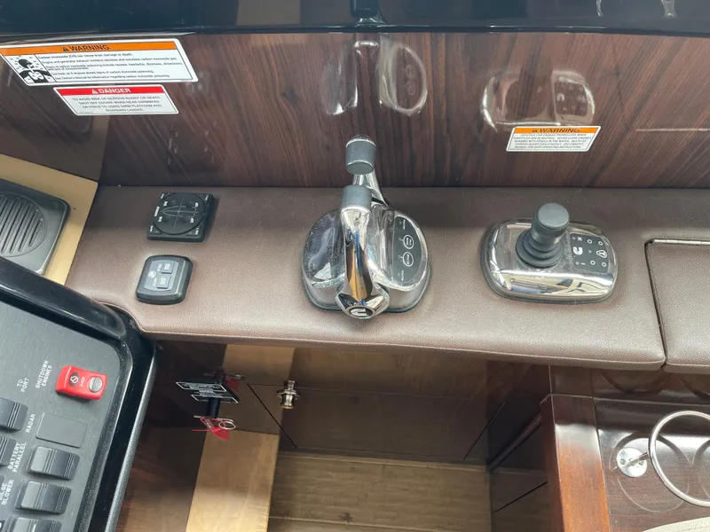 Slide: The Image of Control panel of a 2017 Sea Ray Fly 400 yacht with throttle and joystick. - 34