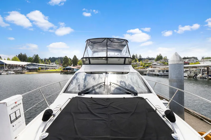 Slide: The Image of 2017 Sea Ray Fly 400 yacht docked at marina under clear blue sky. - 4