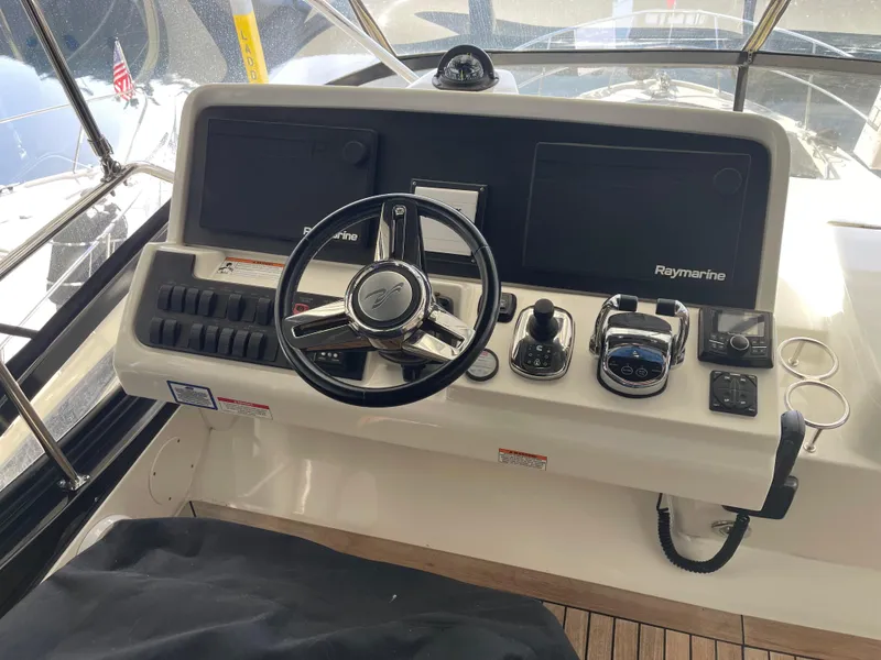 Slide: The Image of Control panel of 2017 Sea Ray Fly 400 yacht with steering wheel and navigation equipment. - 47