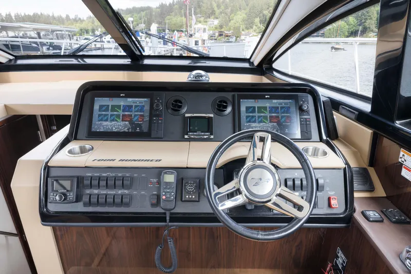 Slide: The Image of 2017 Sea Ray Fly 400 helm with dual displays and modern controls. - 5