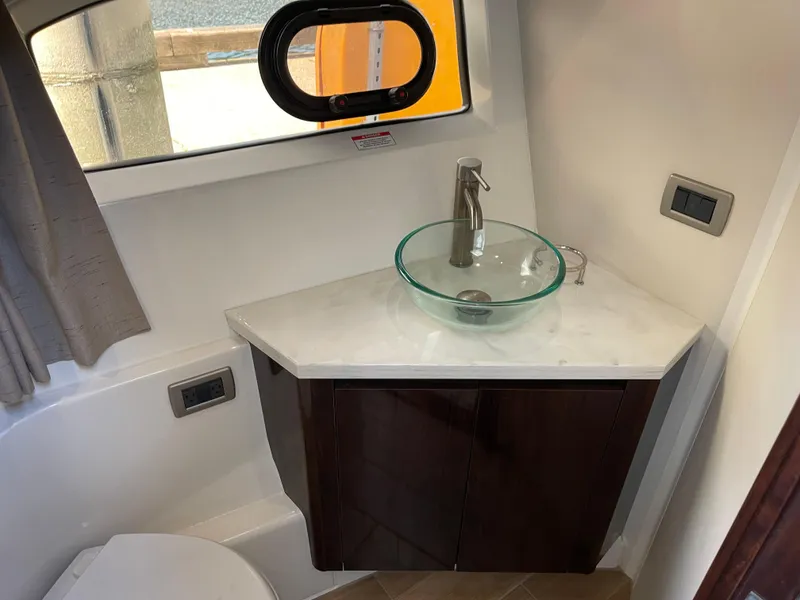 Slide: The Image of Modern bathroom in 2017 Sea Ray Fly 400 yacht with glass sink and sleek fixtures. - 52