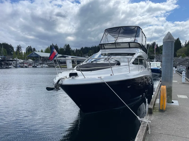 Slide: The Image of 2017 Sea Ray Fly 400 yacht docked at marina under cloudy sky. - 56
