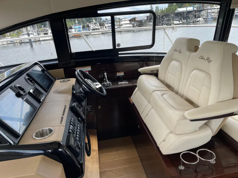 Slide: The Image of 2017 Sea Ray Fly 400 yacht interior with dual captain seats and control panel. - 58