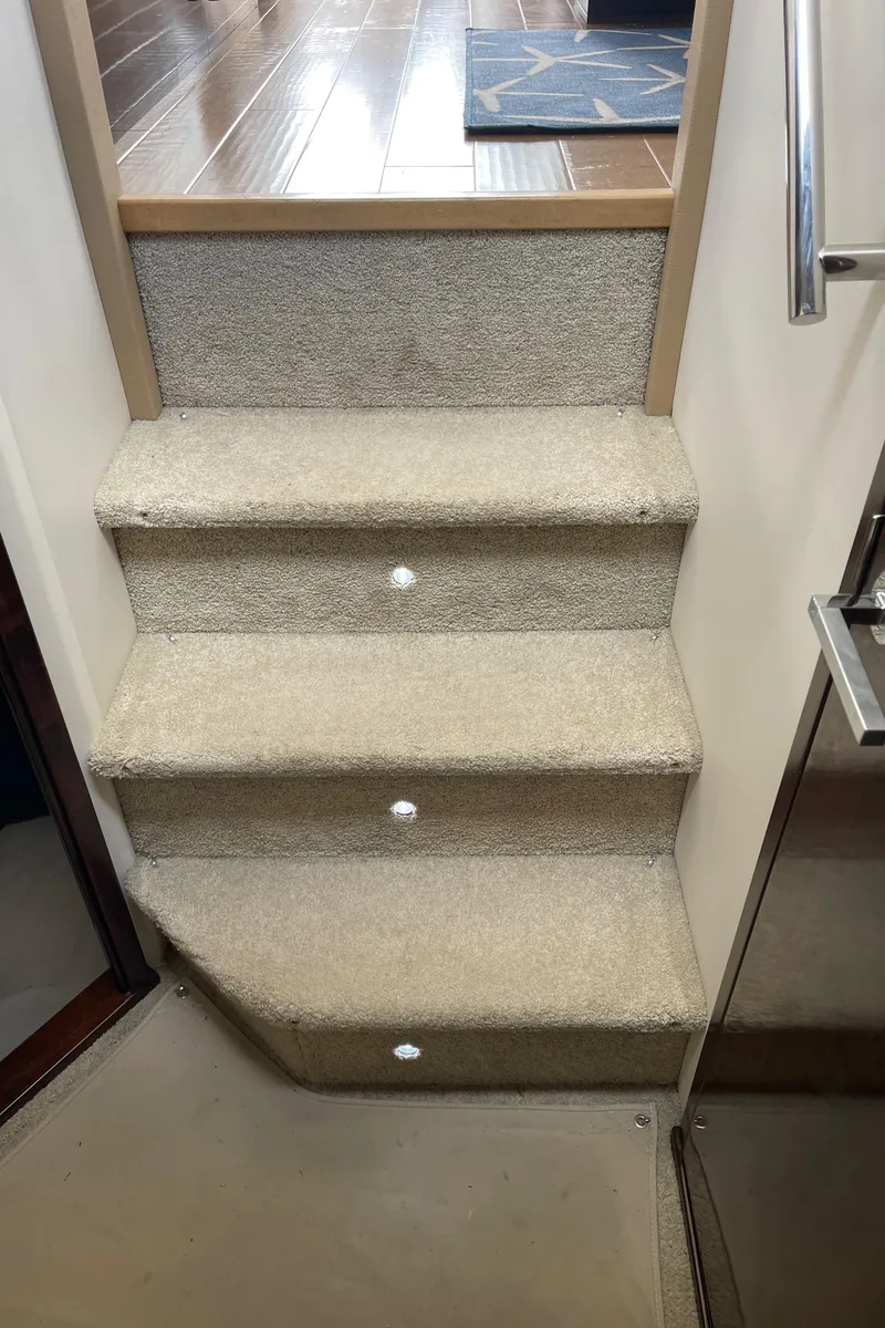 Slide: The Image of Carpeted stairs inside a 2017 Sea Ray Fly 400 yacht. - 62