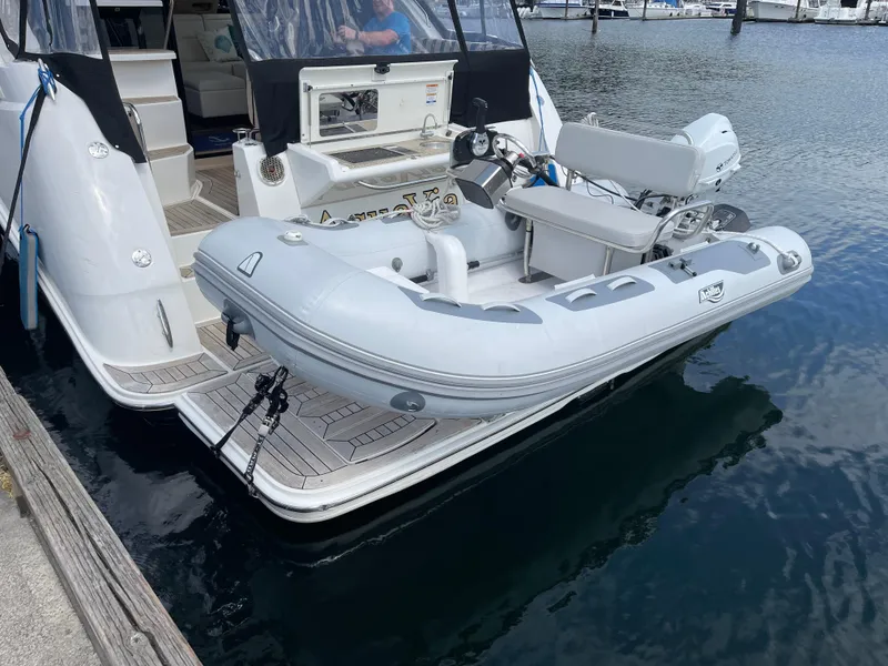 Slide: The Image of 2017 Sea Ray Fly 400 yacht with attached inflatable dinghy at marina. - 63