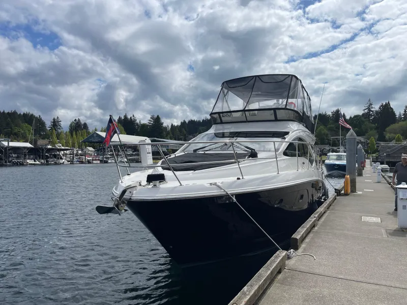 Slide: The Image of 2017 Sea Ray Fly 400 yacht docked at a marina under cloudy skies. - 64