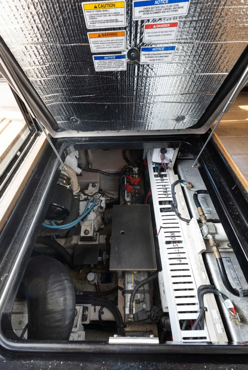 Slide: The Image of Engine compartment of a 2017 Sea Ray Fly 400 boat, showcasing mechanical components. - 66