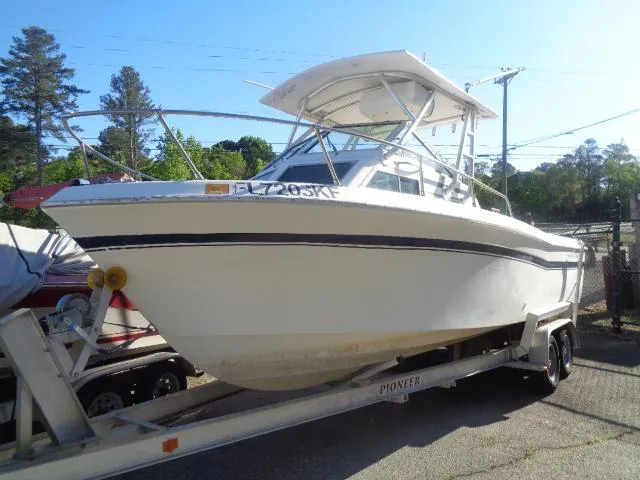 The Image of 1980 Grady-White 241 WEEKENDER boat on trailer, parked outdoors. - 1