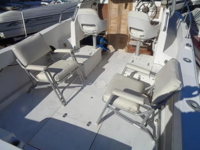 Slide: The Image of 1980 Grady-White 241 WEEKENDER boat interior with seating and steering wheel. - 12