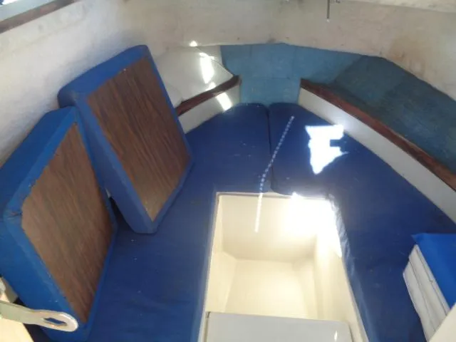 Slide: The Image of Interior cabin of 1980 Grady-White 241 WEEKENDER with blue cushions and storage compartment. - 6