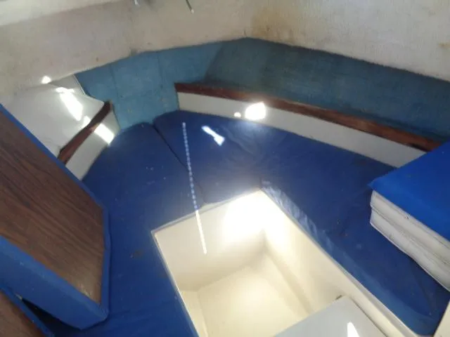 Slide: The Image of 1980 Grady-White 241 WEEKENDER cabin interior with blue cushions and storage compartment. - 7