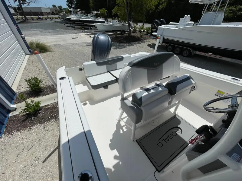 Slide: The Image of 2021 Robalo R242 Explorer boat interior with seating and steering console. - 10