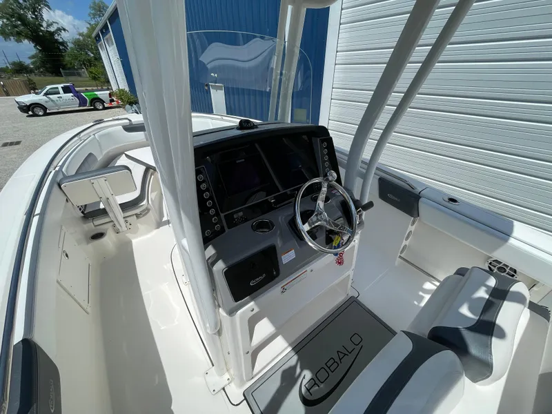 Slide: The Image of 2021 Robalo R242 Explorer boat interior with steering console and seating. - 13