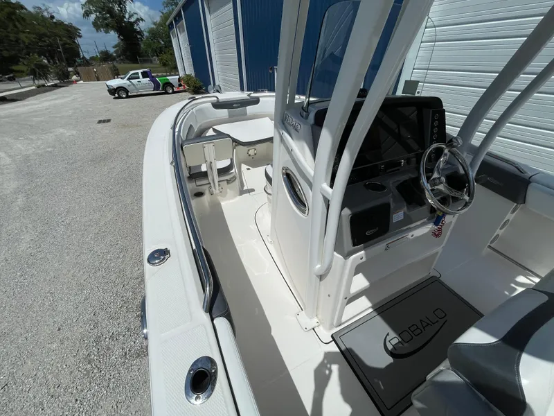 Slide: The Image of 2021 Robalo R242 Explorer boat interior with steering console and seating. - 14