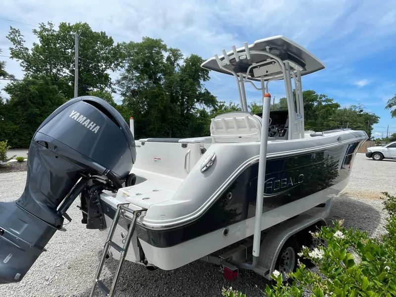 Slide: The Image of 2021 Robalo R242 Explorer boat with Yamaha engine on a trailer, parked outdoors. - 4