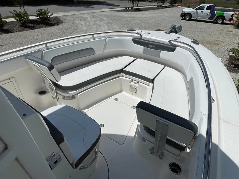 Slide: The Image of 2021 Robalo R242 Explorer boat interior with white seating and spacious deck. - 6